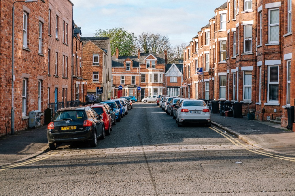 A residential street in Belfast with red-brick terrace houses
